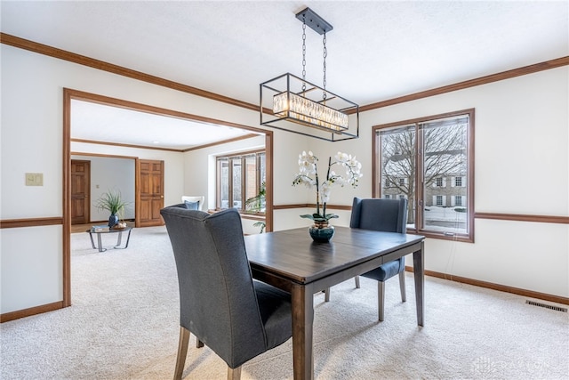 carpeted dining space featuring ornamental molding