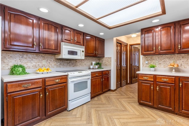 kitchen featuring light parquet flooring, backsplash, and white appliances