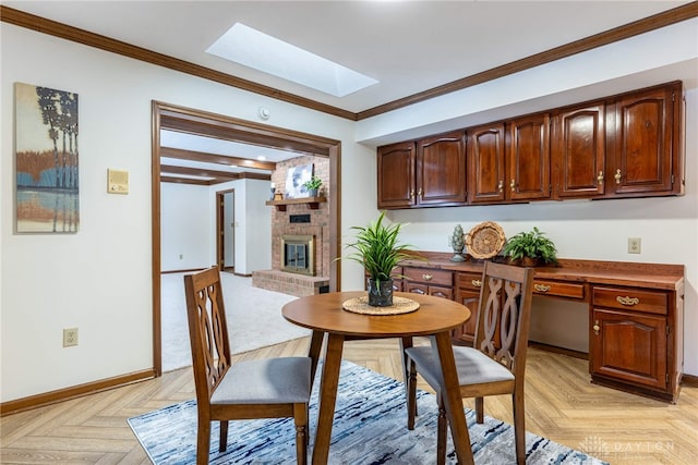 dining space with crown molding, a fireplace, a skylight, and light parquet floors