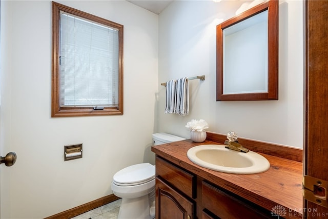 bathroom featuring tile patterned flooring, vanity, and toilet