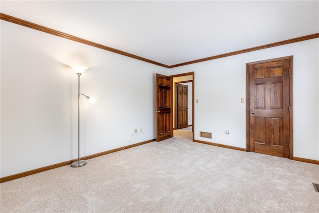 carpeted spare room featuring crown molding