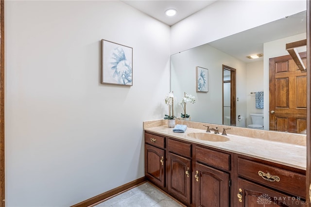 bathroom featuring vanity, tile patterned floors, and toilet