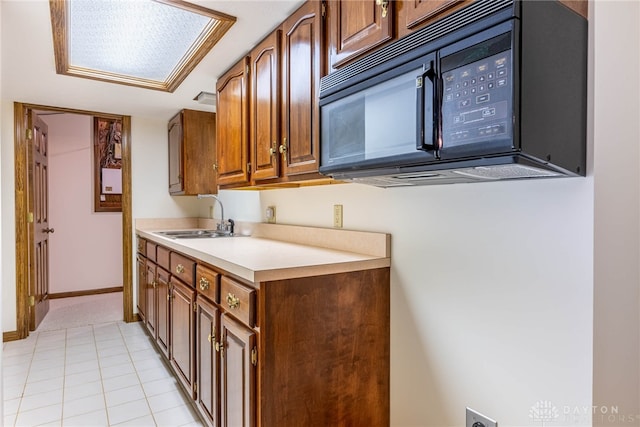 kitchen with light tile patterned flooring and sink