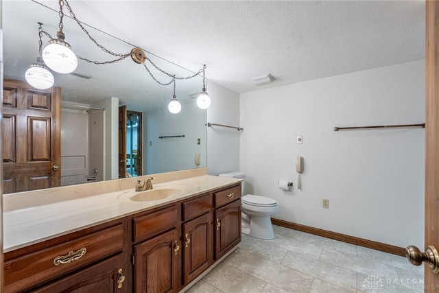 bathroom featuring vanity, toilet, and a textured ceiling