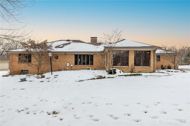 view of snow covered rear of property