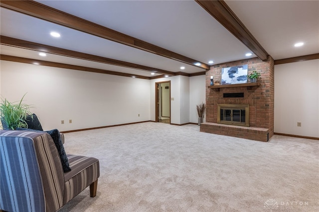 living room featuring beam ceiling, light colored carpet, and a fireplace