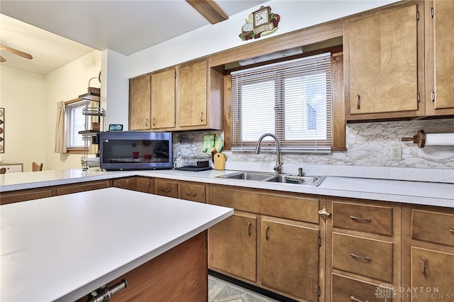 kitchen with tasteful backsplash, sink, and ceiling fan