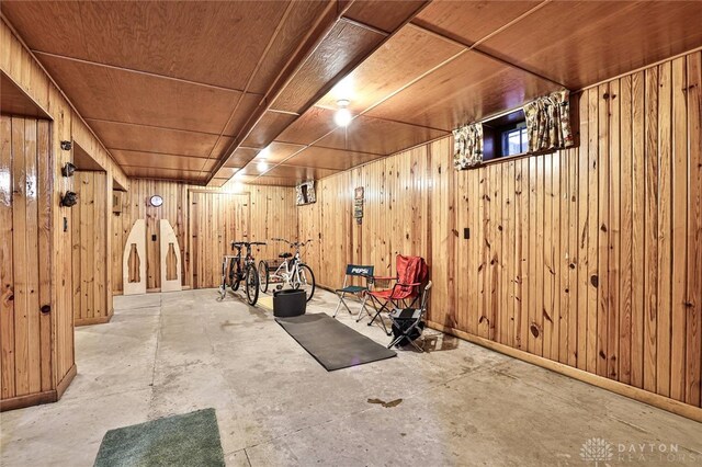 basement with wooden ceiling and wood walls