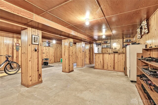 basement with wooden ceiling and wood walls