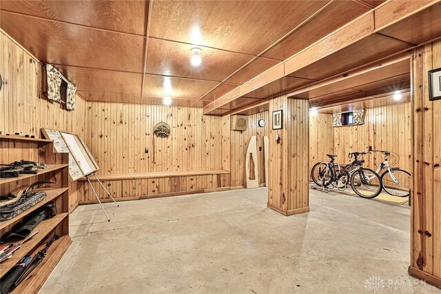 basement with wood ceiling and wooden walls