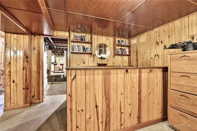 bar featuring wood ceiling and wood walls