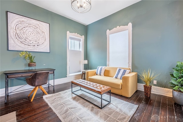 living area featuring hardwood / wood-style flooring and a chandelier