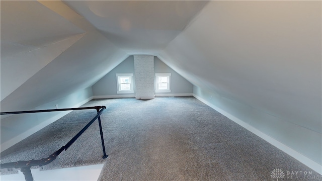 bonus room featuring vaulted ceiling and carpet