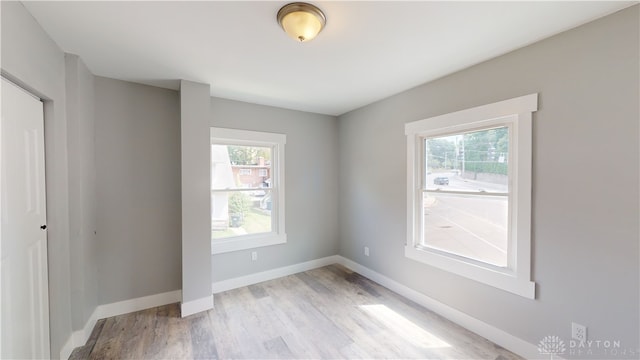 empty room with light hardwood / wood-style flooring