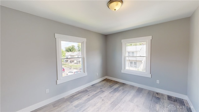 unfurnished room with light wood-type flooring