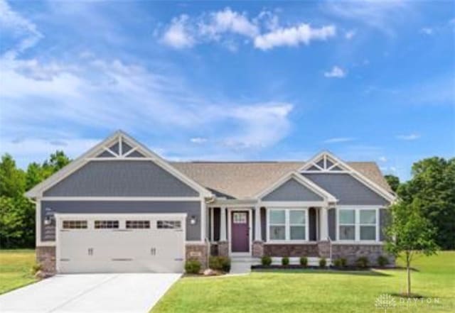 craftsman-style house featuring a garage and a front lawn