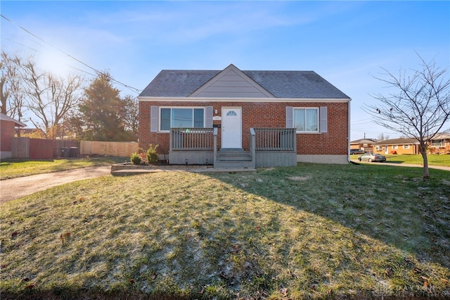 bungalow-style home featuring a front lawn