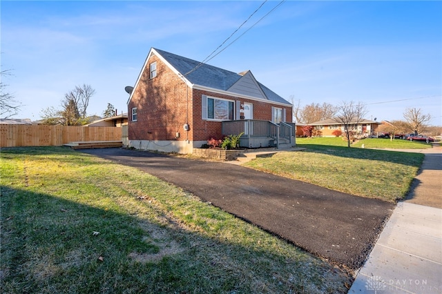 view of side of home featuring a lawn