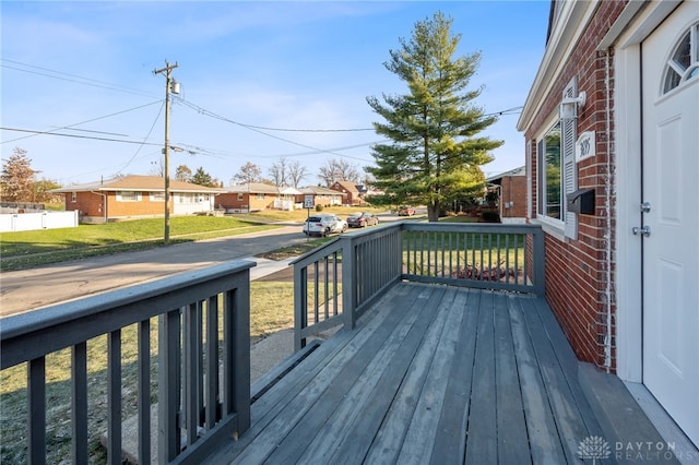 wooden deck with a lawn