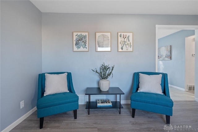 sitting room with hardwood / wood-style flooring