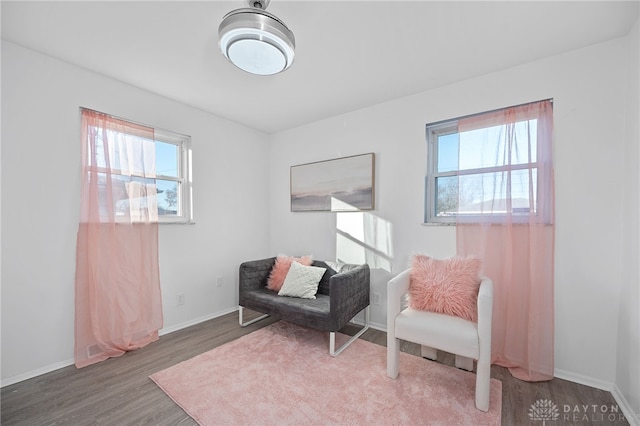 living area with hardwood / wood-style flooring