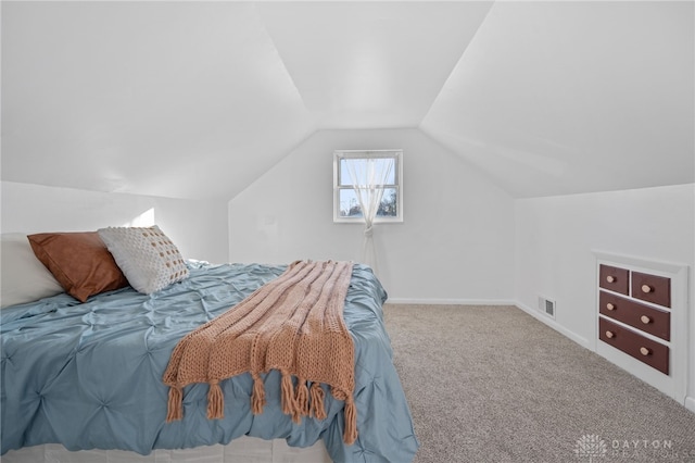 bedroom with lofted ceiling and carpet flooring