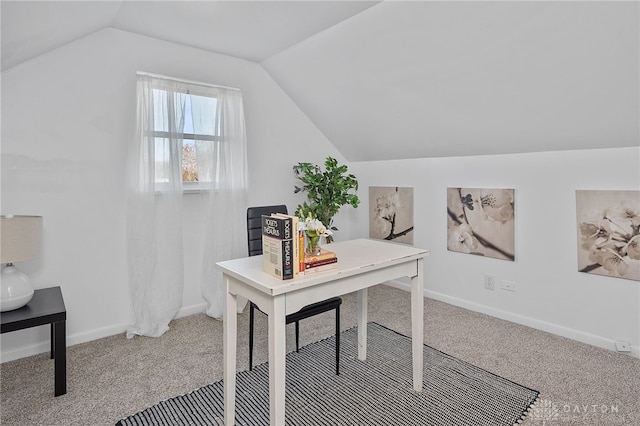 carpeted home office with vaulted ceiling