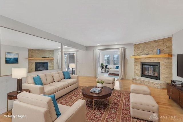 living room with a fireplace and light hardwood / wood-style floors