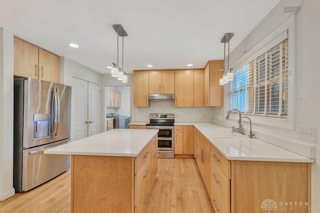 kitchen with pendant lighting, light brown cabinets, a center island, and appliances with stainless steel finishes