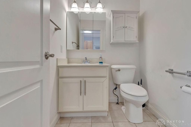 bathroom featuring vanity, tile patterned floors, and toilet