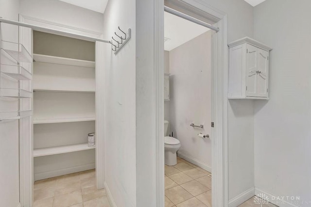 bathroom with tile patterned floors and toilet