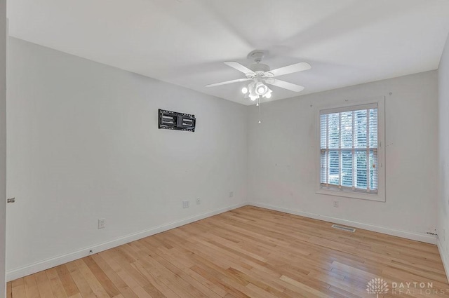 empty room featuring ceiling fan and light hardwood / wood-style floors