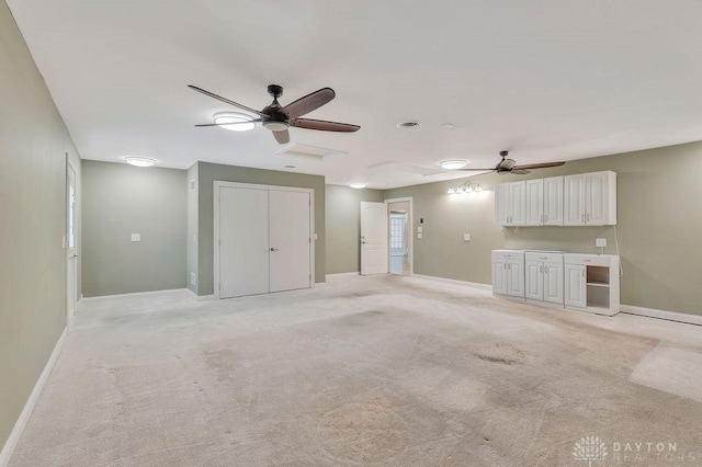 interior space with ceiling fan