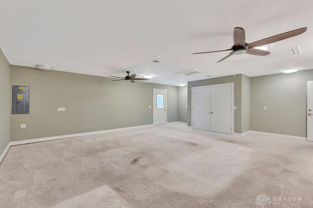 carpeted empty room featuring ceiling fan and electric panel