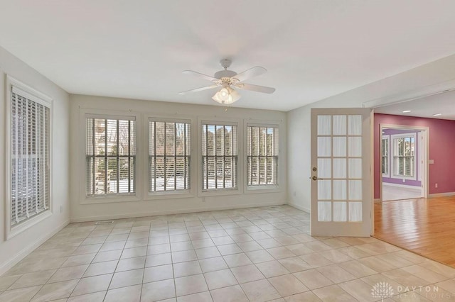 unfurnished room featuring light tile patterned floors and ceiling fan