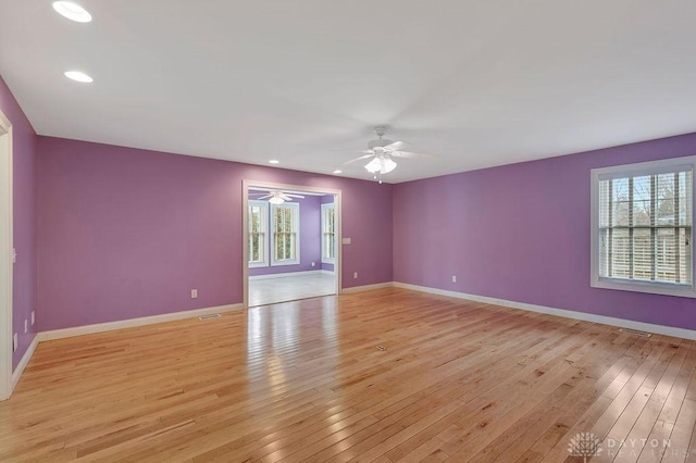 spare room with light hardwood / wood-style flooring and ceiling fan