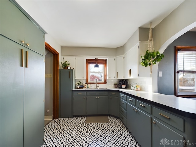 kitchen with white cabinetry, plenty of natural light, sink, and tasteful backsplash