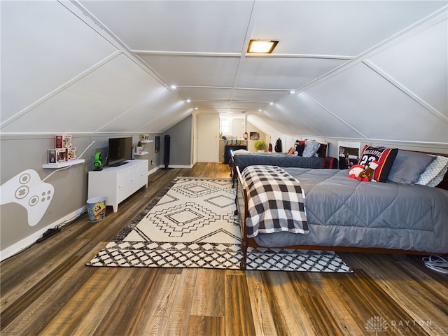 bedroom with dark wood-type flooring and vaulted ceiling