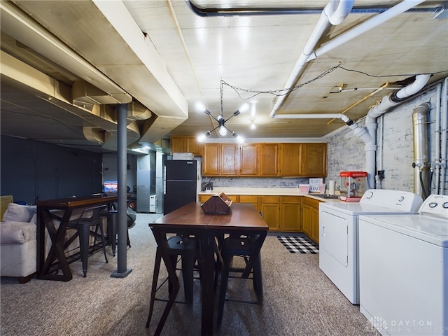 interior space with carpet flooring, washer and dryer, and black fridge