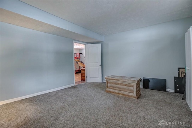 unfurnished bedroom featuring carpet and a textured ceiling