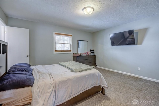 carpeted bedroom with a textured ceiling