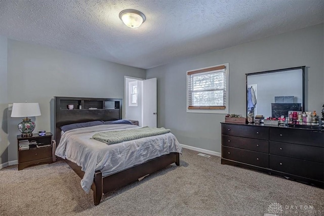 carpeted bedroom featuring a textured ceiling