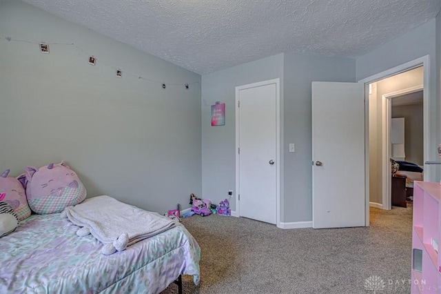 bedroom featuring light carpet and a textured ceiling