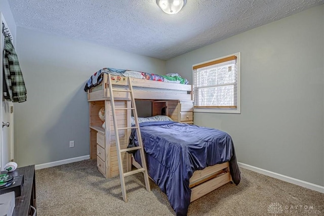 carpeted bedroom featuring a textured ceiling