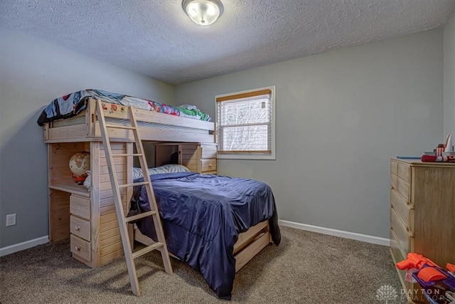 bedroom with carpet floors and a textured ceiling