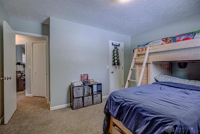 carpeted bedroom featuring a textured ceiling