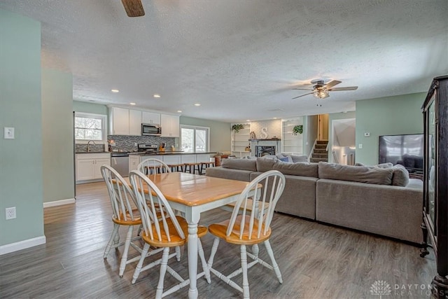 dining space featuring ceiling fan, a healthy amount of sunlight, and light wood-type flooring