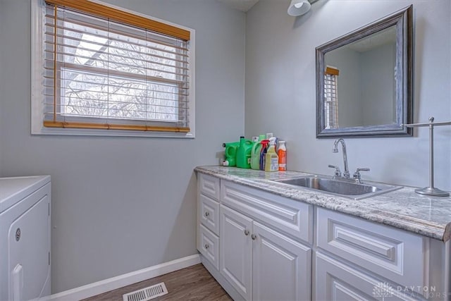 bathroom with vanity, hardwood / wood-style floors, and washing machine and clothes dryer