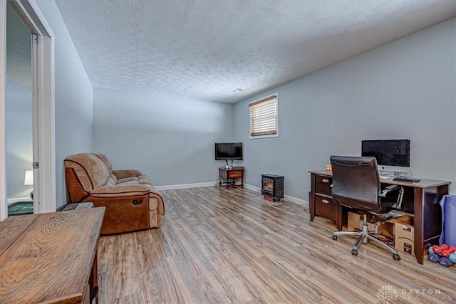 office featuring a textured ceiling and light wood-type flooring