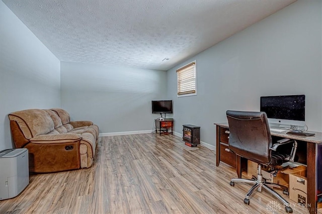 office featuring a textured ceiling and light wood-type flooring